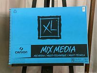Front view of Canson XL Mix Media Pad with blue cover, spiral bound, jumbo size 18 x 24 inches, 30 sheets, 98 lb weight