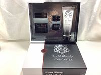 Full view of opened gift set box containing Eau de Parfum bottles and 3-in-1 shampoo, conditioner, body wash tube.