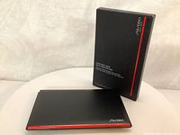 Packed Shiseido Synchro Skin Self-Refreshing Powder Foundation box and compact with red trim detail on compact.