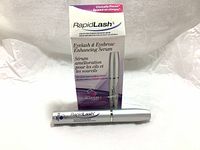 Front view of box and tube of RapidLash Eyelash and Eyebrow Enhancing Serum showing branding and product information.