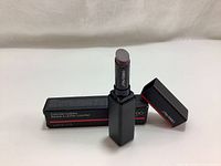 Shiseido ColorGel Lip Balm Lipstick 110 Jupiter opened showing the lipstick bullet and cap next to the box.