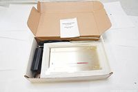 Opened box view of the aluminum external hard drive enclosure inside styrofoam with power adapter and manual.