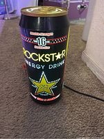Large light-up Rockstar energy drink can lamp, showing front branding and 16 oz size.