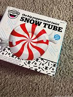 Photo of the box of the peppermint twist snow tube showing its design and branding.