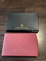 Closed black outer box and maroon display case with Royal Canadian Mint branding.