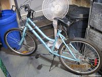 Side profile of light blue step-through bicycle showing entire frame and wheels