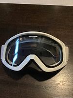 Front view of the single pair Gordini snow/ski board goggles showing white frame and clear lens.