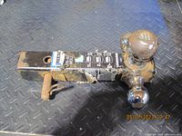 Image showing entire Reese Tow Power multiple-ball mount lying on steel floor with black paint scratched and balls attached.