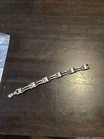 Full view of the silver bracelet showing the link style and overall condition.