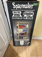 Photo of the Spacemaker shelving packaging box front side showing product image and branding.