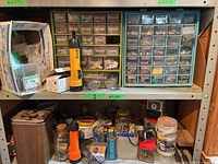 Two shelves with assorted hardware organizers, tools, and containers