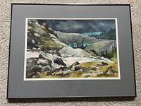 Full view of the framed watercolor painting showing the mountainous landscape with river and vegetation.