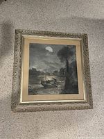 Frontal view of framed charcoal drawing on carpeted floor