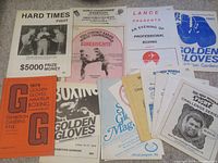 Photo of vintage Vancouver boxing event programs and flyers from 1978 to 1983 arranged flat, showing a variety of colors, promotional titles, and boxer images.