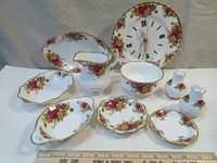 Full view of the ten bone china accent pieces including wall clock, dishes, milk jug, sugar bowl, salt and pepper shakers.