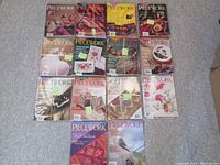 Overview photo shows multiple stands of Piecework Magazine issues laid out on carpet, bound with string and tagged.