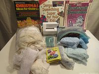 Full view of lot showing lace trims, books, wooden buttons, and Sidekick cutter