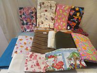 Overview of all 16 fabric pieces in the lot showing variety of prints, colors, and textures including sixties psychedelic print and Pendleton wool remnant