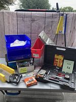 Photo of emergency car tool kit in black case with various hand tools and emergency caution sign.