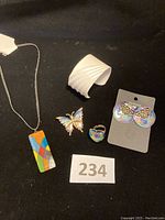 Full set of vintage jewelry including necklace, cuff bracelet, butterfly pin, ring, and butterfly earrings shown together