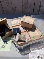 Image of boxes containing the string lights and the coiled copper wire string lights with LEDs, solar panel visible.