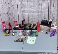 Full lot of decorative shoe figurines arranged on table including various colors, shapes, and materials.