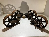Four 9.5 inch steel casters arranged in a group showing their metal wheels and mounting brackets with visible rust and wear.