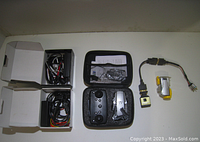 Full view from above showing the drone and controller in a hard case, underwater video camera to the right, HD Fury 2 converter device, and two separate boxes with various IDE cables inside.