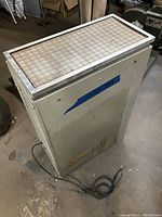 Full view of the JDS Air Filtration System with visible power cord and metal mesh top cover.