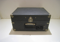 Exterior view of the closed black carrying case with metal reinforcements and handle of the vintage Califone record player.