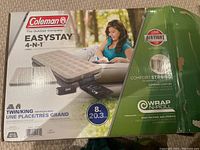 Box of Coleman Easystay 4-in-1 air bed showing model, size, and features including 8 inch thickness, twin/king configuration, supports up to 300 pounds, and one year airtight warranty.