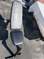 Top view of the adjustable workout bench showing padded backrest and seat with black vinyl.