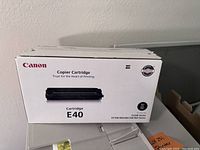 White box of Canon Copier Cartridge E40 with product details and compatibility