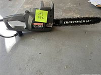 Side view of the Craftsman electric chainsaw showing the body, bar, and power cord.
