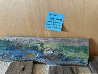 Close-up of long wood plank with hand painted ducks and pond scene.