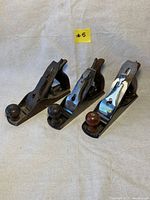 Three antique Stanley No. 3 wood planes together showing front and rear views and general condition.