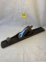 Full side view of antique Stanley No.7 wood plane on white backdrop with sticker labeled #10