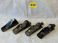All four block planes laid out on a cloth showing one non-Stanley plane and three Stanley 118 models