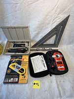 Overview photo of all tools included: Dremel rotary tool kit, Laser Level Pro 3, speed square, and Black & Decker Bullseye laser level.