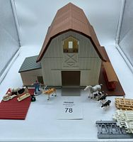Front view of barn with animal figures and farm accessories spread around it, showing scale and details.