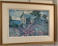 Full front view of framed painting depicting a rustic stone house with a garden of pink cosmos flowers, under a partly cloudy sky.