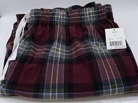 Folded view of men's plaid pyjama pants showing color and pattern detail, along with elastic waistband and drawstring.