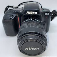 Front view of Nikon F50 camera with attached 35-80mm lens and Nikon lens cap on.