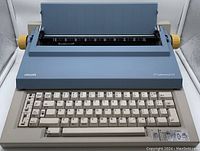 Front view of Olivetti ET Personal 55 typewriter showing keyboard and paper holder area, highlighting the compact design and overall condition.
