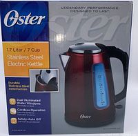 Front box image showing the Oster electric kettle with product details including 1.7 liter capacity, durable stainless steel construction, cordless operation, dual illuminated water windows, and safety auto-off.