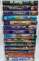 Front view of VHS tapes stacked showing titles and clamshell cases