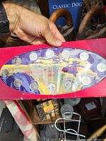 Top view of 2000 millennium coin set in original packaging, showing twelve silver-colored coins arranged in a row with globe and star design on insert.