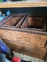 Woven rectangular basket made from natural fiber with three compartments, suitable for storage or organizing items.