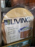 Photo of the bamboo laundry hamper packaging showing brand name 'for LIVING' and laundry hamper image with dimensions.