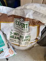 Photo of a sealed bag of Expert Gardener all purpose 3-way mix soil in brown and white packaging showing product details.